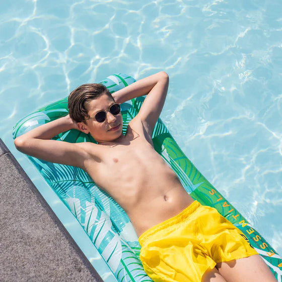 Tropical leaves lie on Luxe version  Pool Inflatable